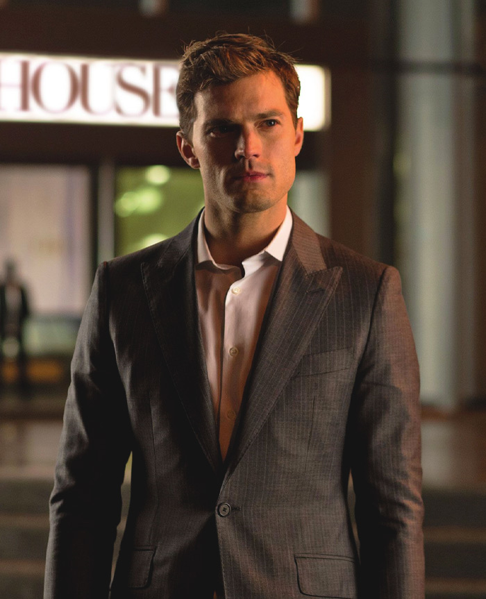 Christian Grey in a grey costume