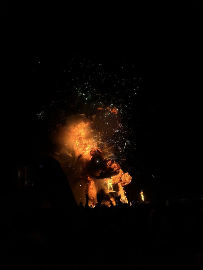 People burning statue 