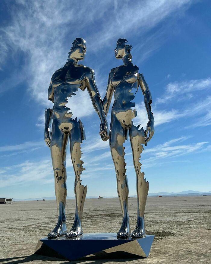 Male and female figures with ripped parts holding hands
