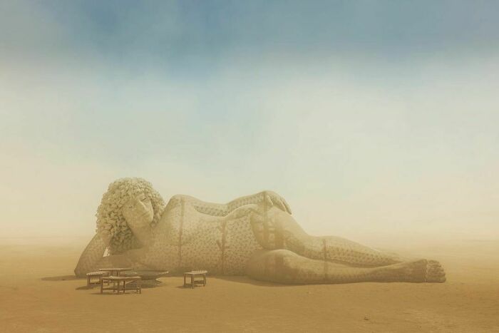 Installation of a female lying in the middle of dessert 