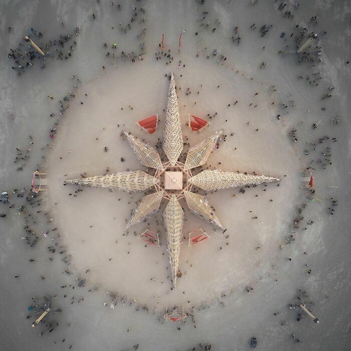 Aerial view of star installation with a lot of people around it 