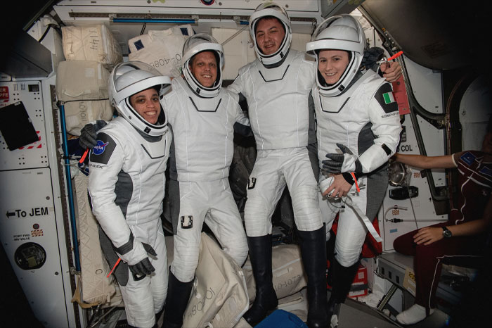 Persons wearing space suits