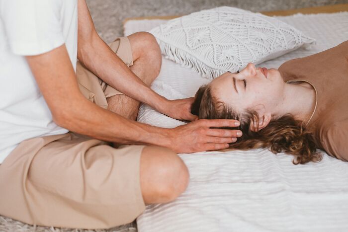 Man Massaging Woman's Face 