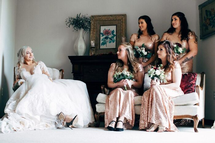 Fiancée And Bridesmaids Holding Flowers In A Room 