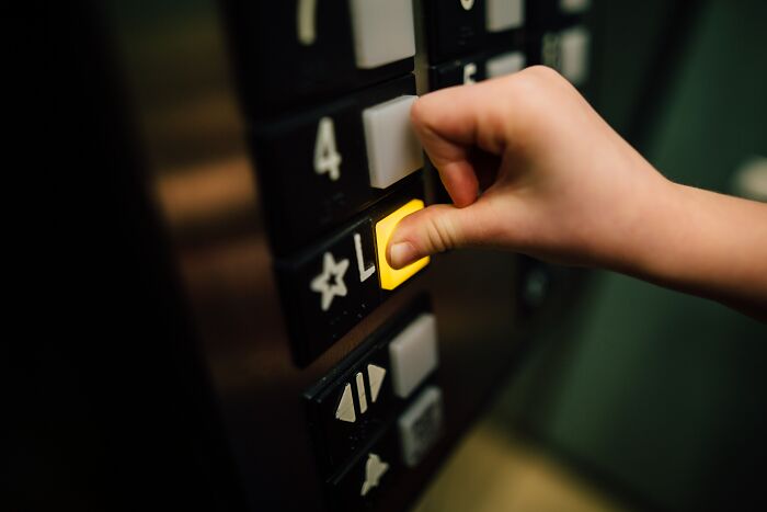 Person Pressing A Button In The Elevator 