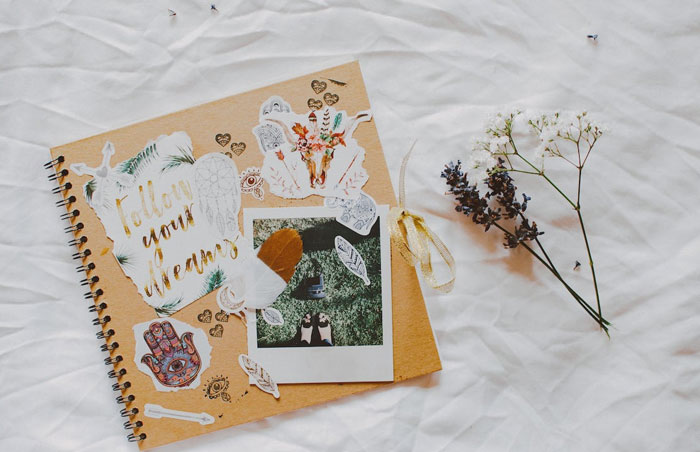 Scrapbook with flower on a bed 