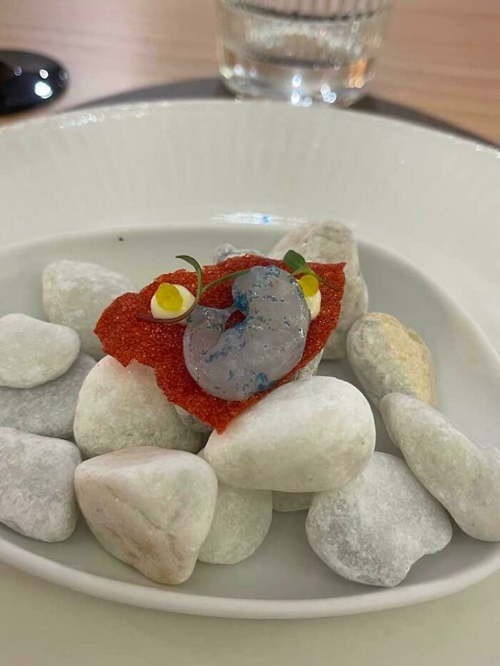 A Single Raw Shrimp Served On Rocks
