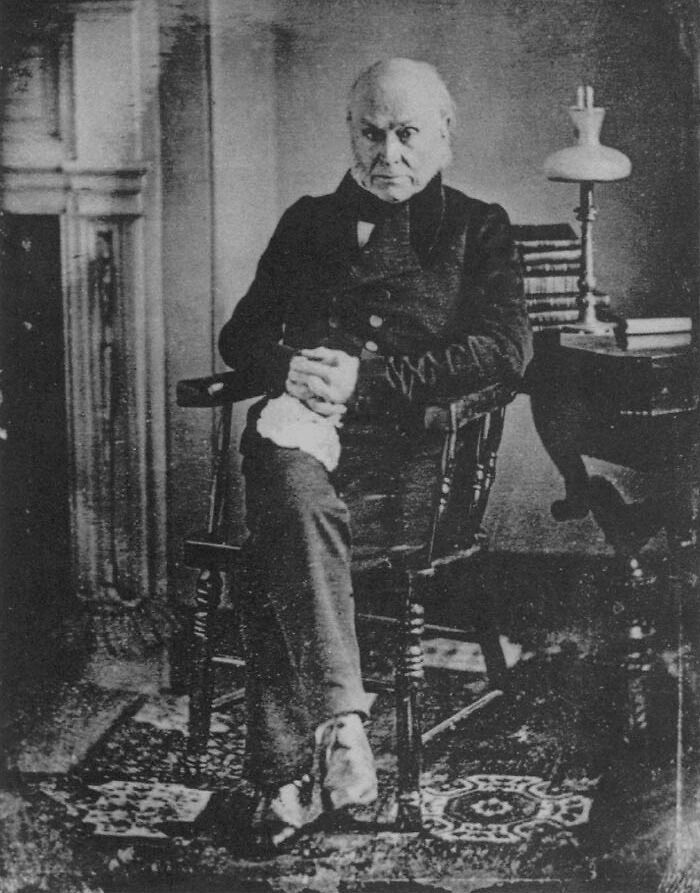 Black and white picture of John Quincy Adams sitting and posing