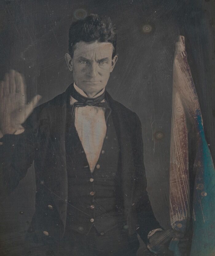 Picture of John Brown holding hand and posing