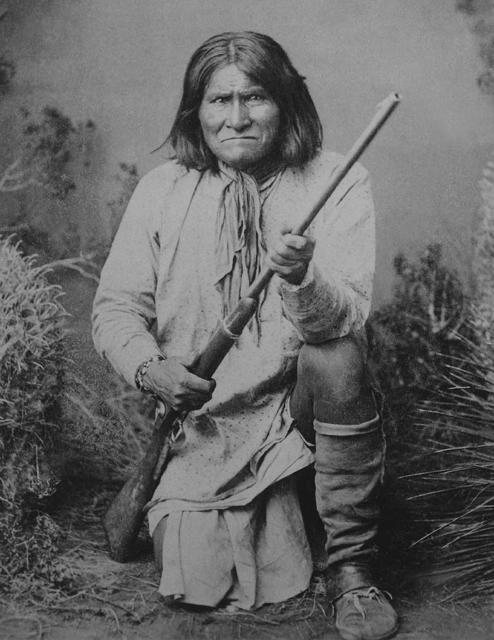 Black and white picture of Geronimo posing with a gun