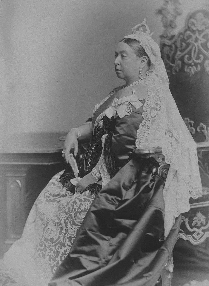 Black and white picture of Queen Victoria sitting and posing