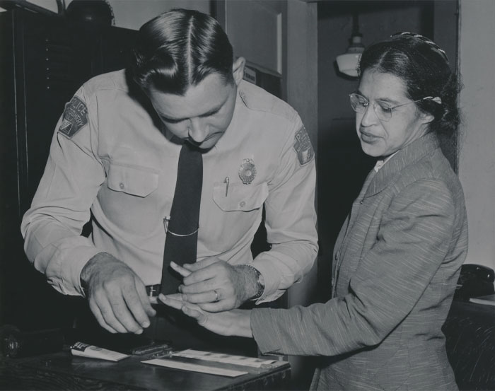 Black and white picture of Rosa Parks with police officer