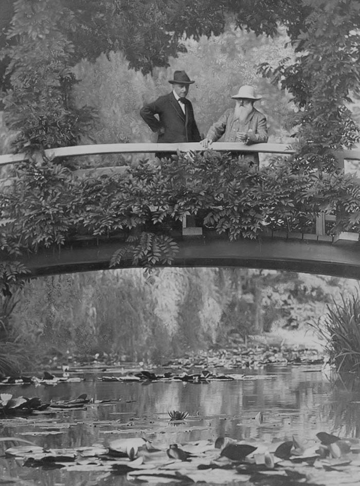 Black and white picture of Claude Monet on the bridge