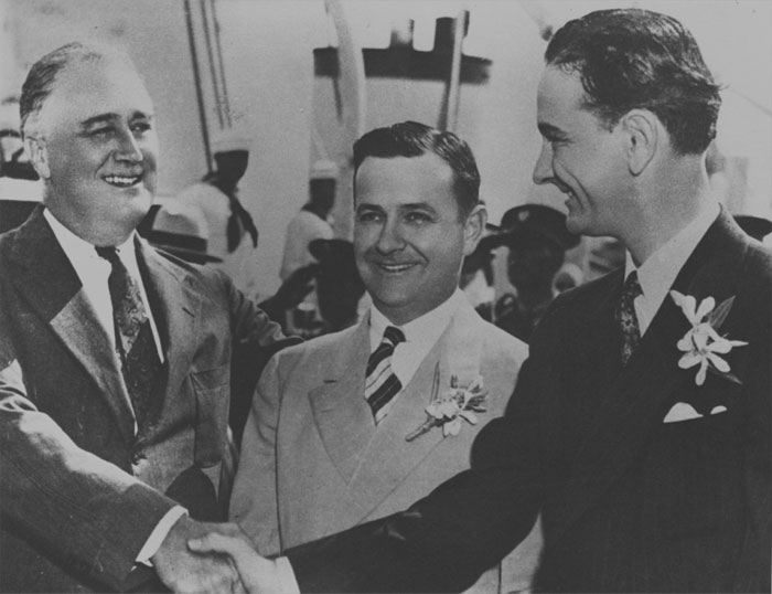 Black and white picture of Franklin D. Roosevelt, Gov. James Allred of Texas and Lyndon B. Johnson in one place