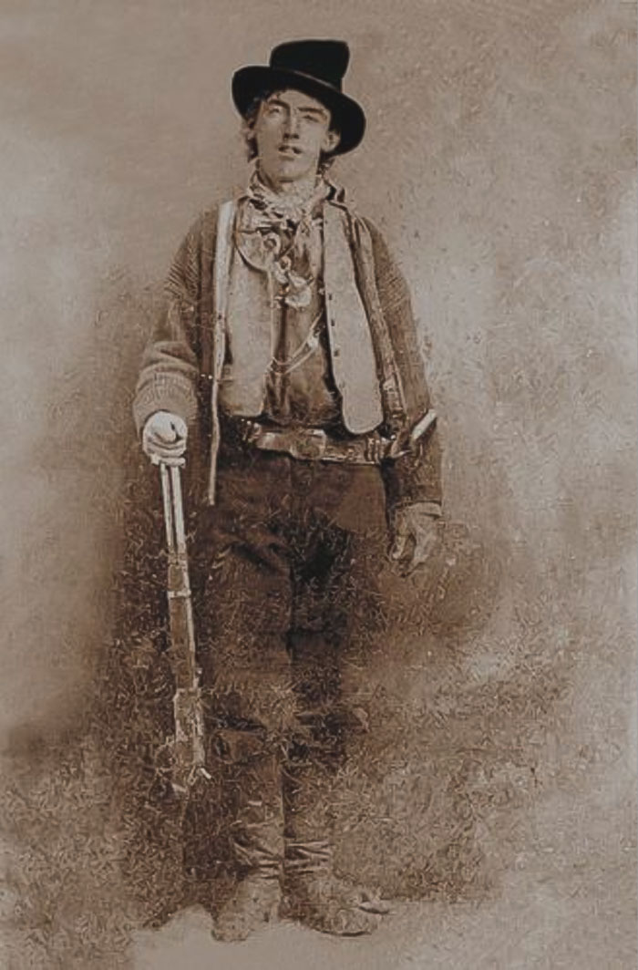 Picture of Billy the kid posing with gun