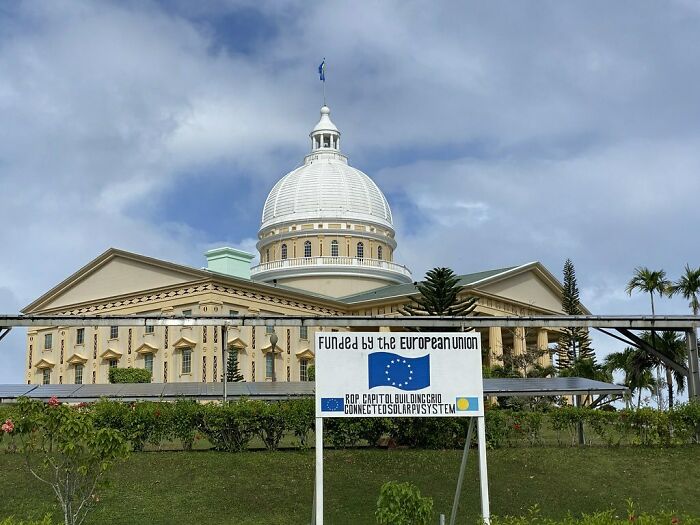 booth with information before the building with the flag on the top