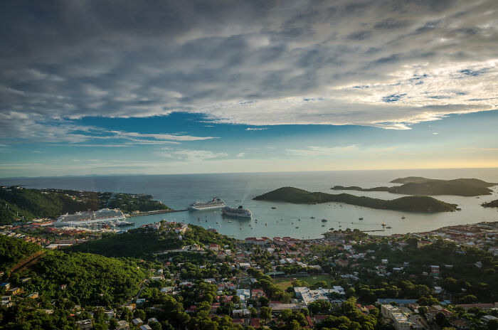 white clouds over the town in the shores of which there are ships