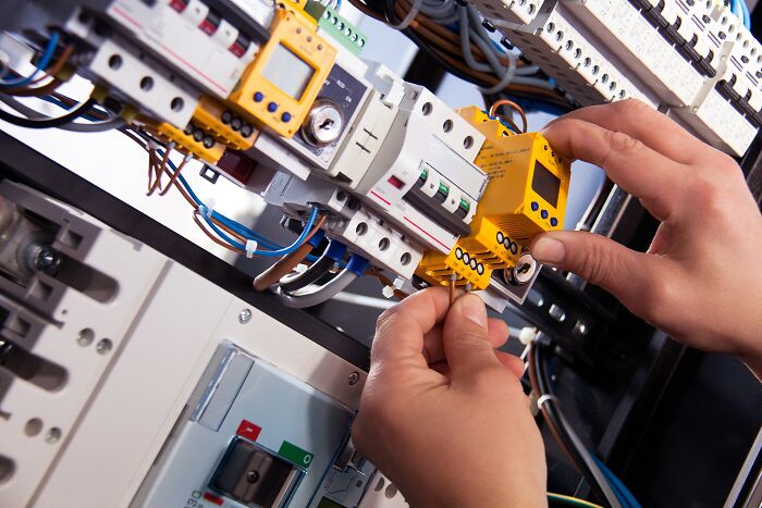 Person Working On Electrical Wiring 