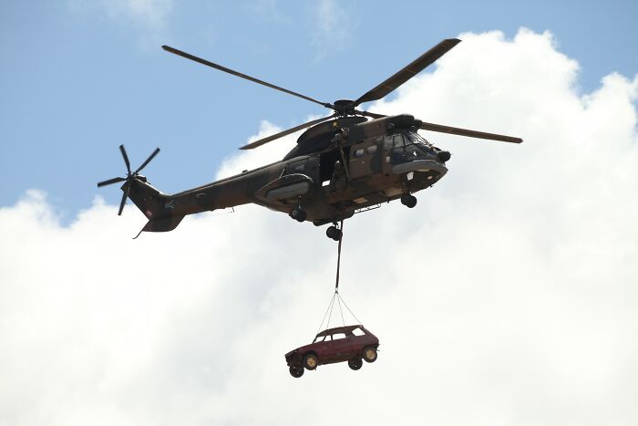 Helicopter Transferring A Car To Other Place 