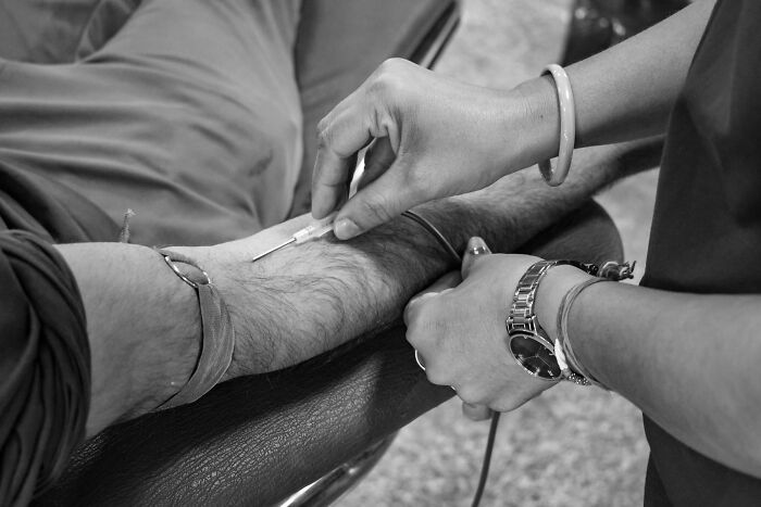 Woman Taking Blood From A Man 