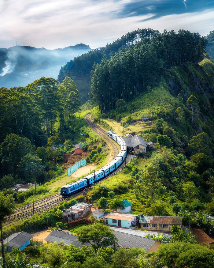 Train Riding Through Small City And Forrest 