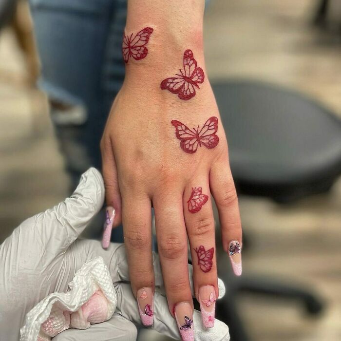 Fine line anatomical heart tattoo in red ink