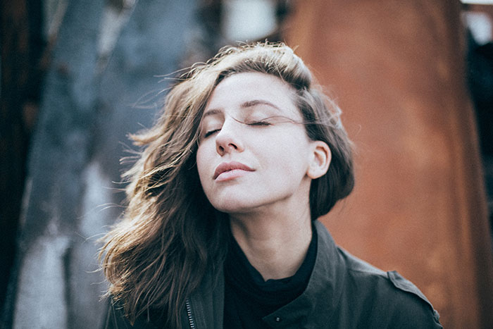 Woman with closed eyes sitting