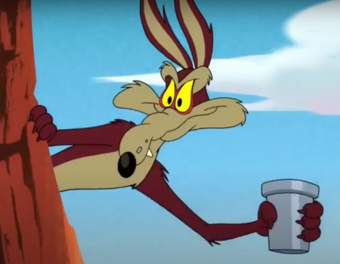 Wile E. Coyote holding a cup 