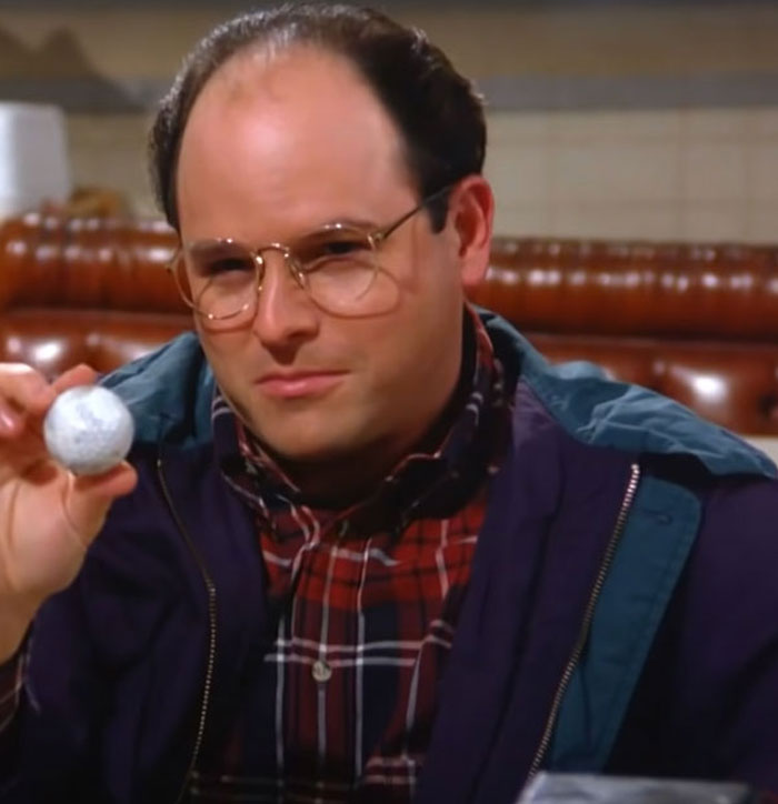 George Costanza holding a golf ball 