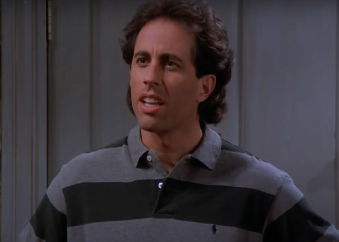 Jerry Seinfeld wearing grey sweater 