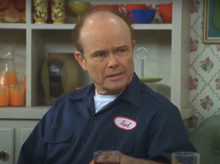 Red Forman siting at the table 
