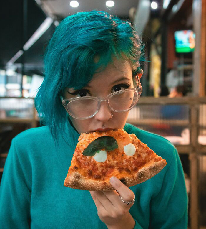 Woman Eating Pizza Slice 