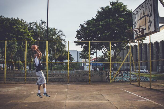Man Playing Basketball Alone 