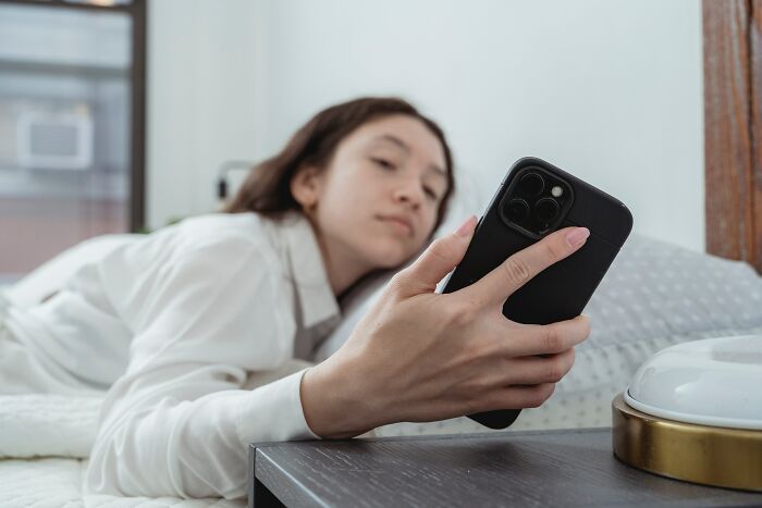 Woman Turning Off Her Phone Alarm 