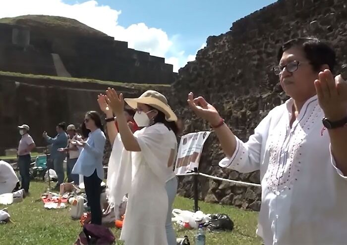 Persons wearing traditional clothes celebrating Mayan ceremony