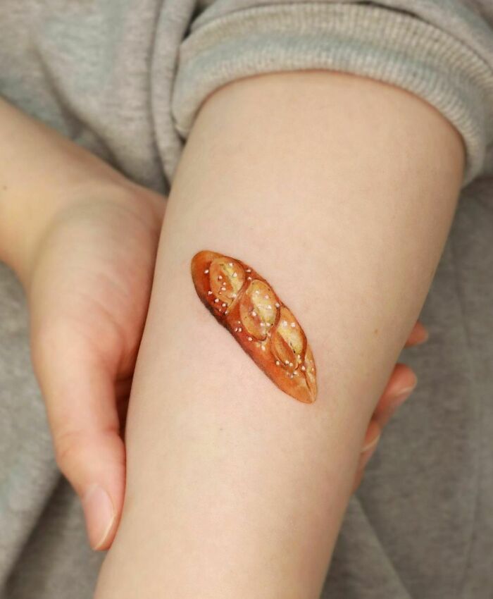 Minimalistic pretzel watercolor tattoo