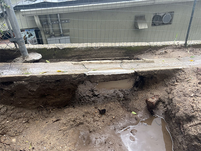 The Dirt Was Washed Away In The Recent Rainstorm And Left The Swale Unsupported. Without The Proper Components, The Swale Can No Longer Function As Intended And Is Allowing The Water To Flow Directly To The Retaining Wall. Would Have Definitely Used That As A Slide If It Was Around When We Were Kids