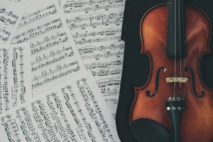 a violin near the paper with notes