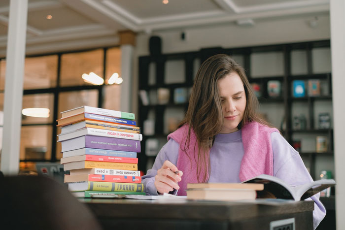 a woman reading a book in the library