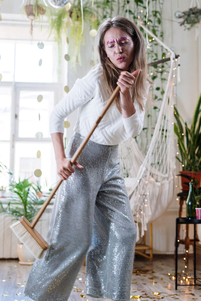 a woman dancing with a mop in her hands