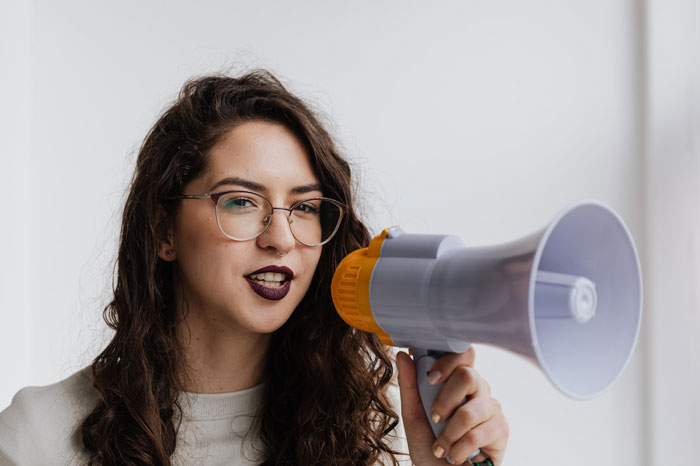 a woman with a load speaker in her hand