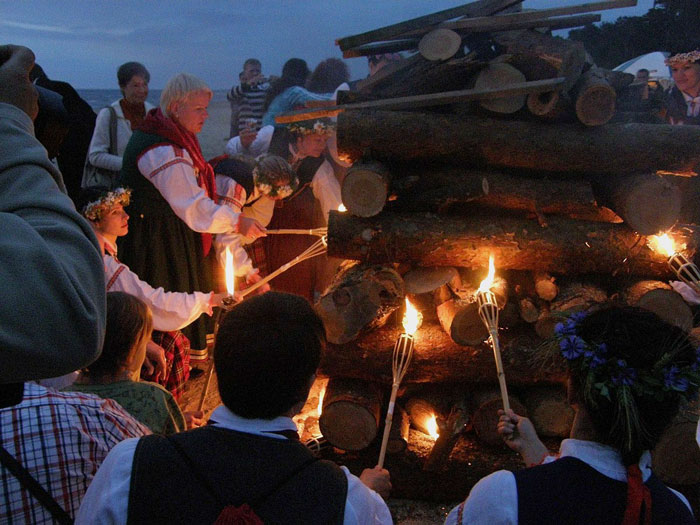 Persons lighting bonfire and celebrates Jāņi Festival