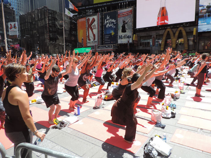 Persons doing yoga in the street