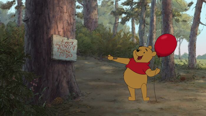 Winnie The Pooh with a balloon in his hands