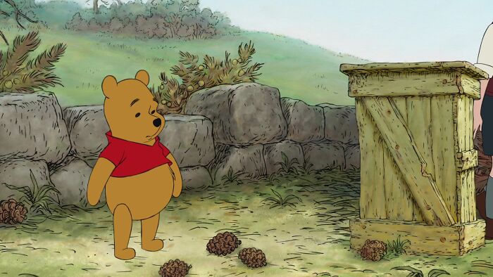 Winnie the Pooh looking at pin cones