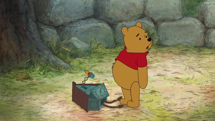 Winnie the Pooh standing near wall clock