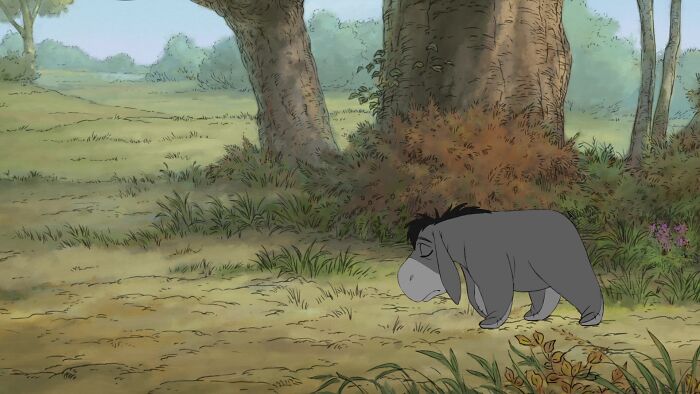 Eeyore from Winnie the Pooh walking with him eyes closed