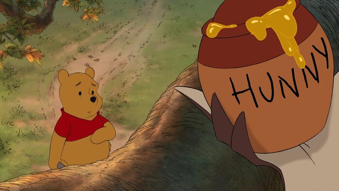 Winnie the Pooh looking at the pot of honey