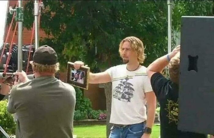 Look At This Photograph Of Nickelback Holding A Photograph While Singing “Look At This Photograph” In The Song ‘Photograph’ Released In 2005