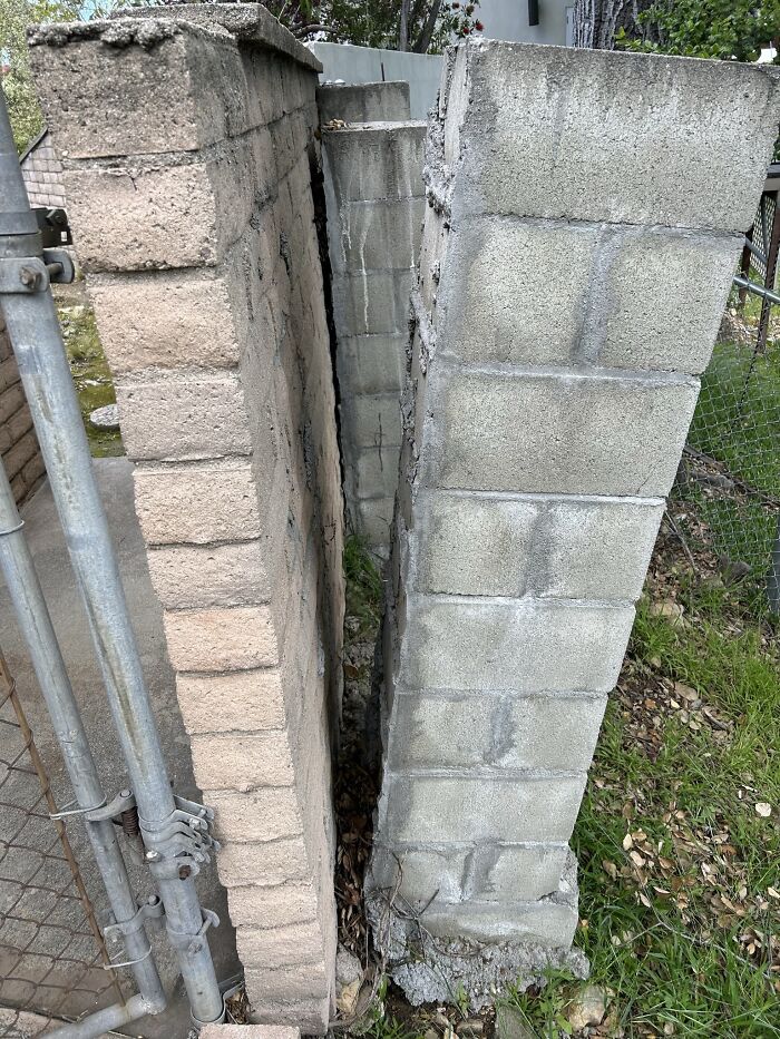 We Assessed This Property Where The Homeowner Had Attempted A DIY Support System For A Block Wall By Building Several Cmu Columns Along The Side Of It. Without The Proper Footings, The Columns Are Now Leaning And Sliding Down The Hill